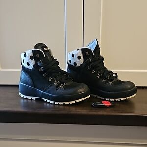 Olang ankle black boots with white trim and black polka dots.